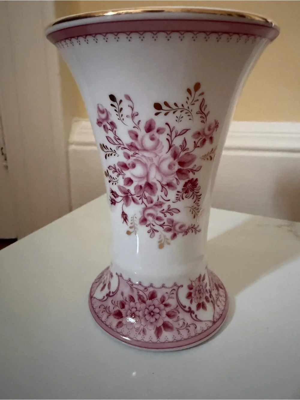 A vintage fluted vase w raspberry floral motif.
